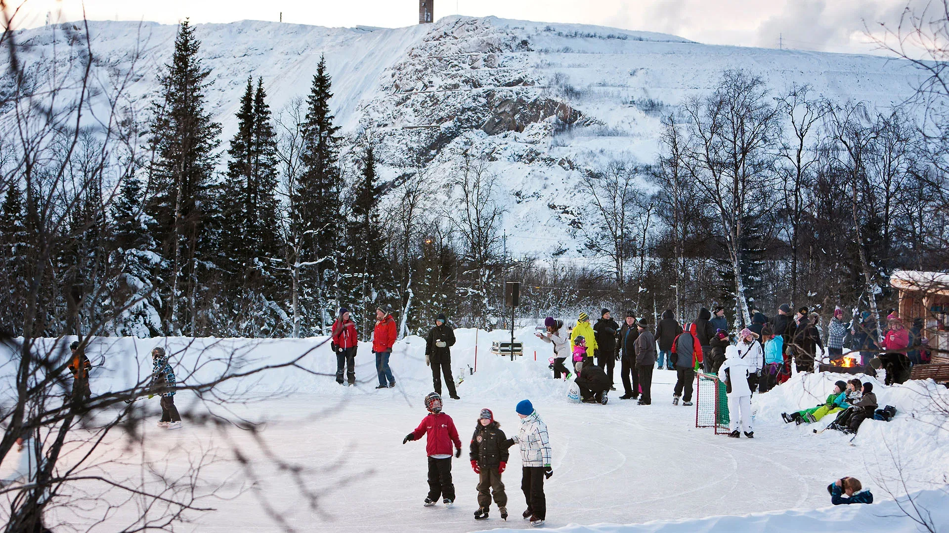 People on a ice rink in winter.