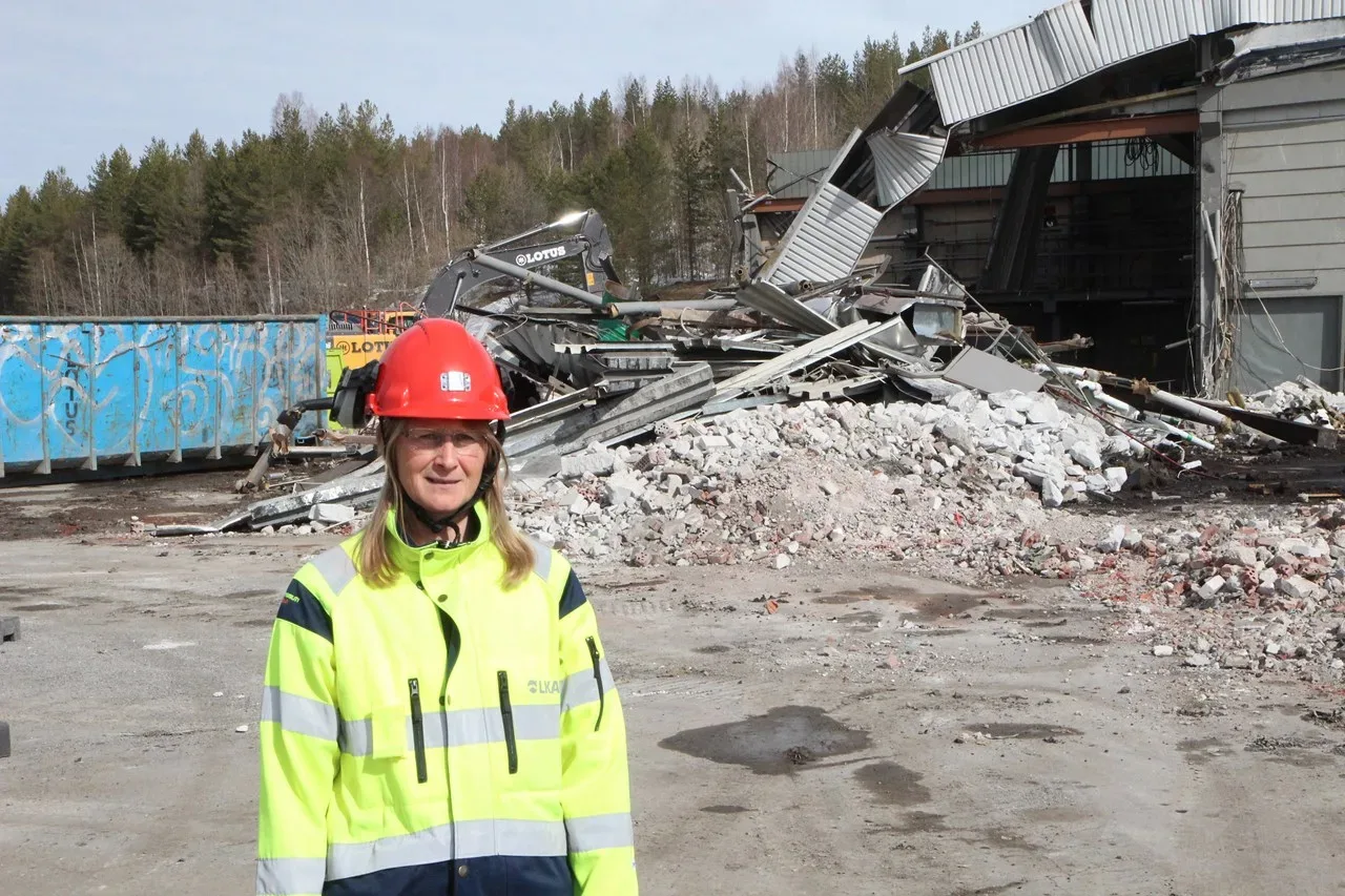 Kvinna framför rivning av hus