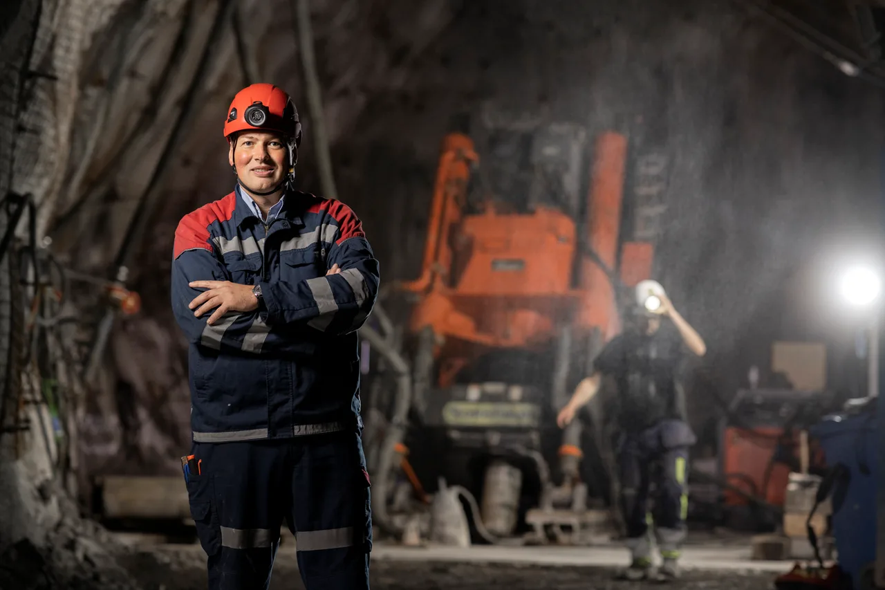 Man in front of machine in underground environment. 