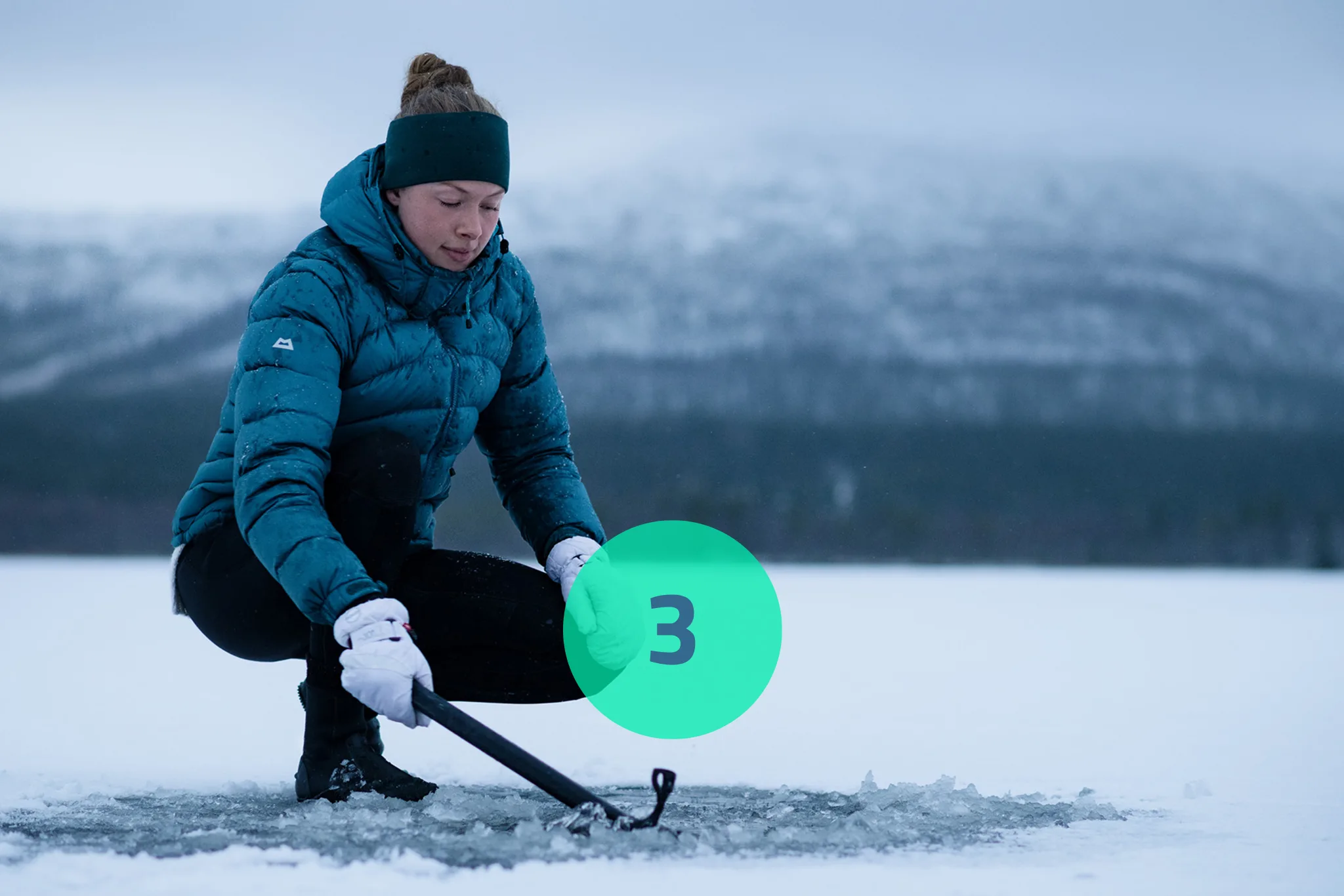 Woman with icepick on a frozen lake. 