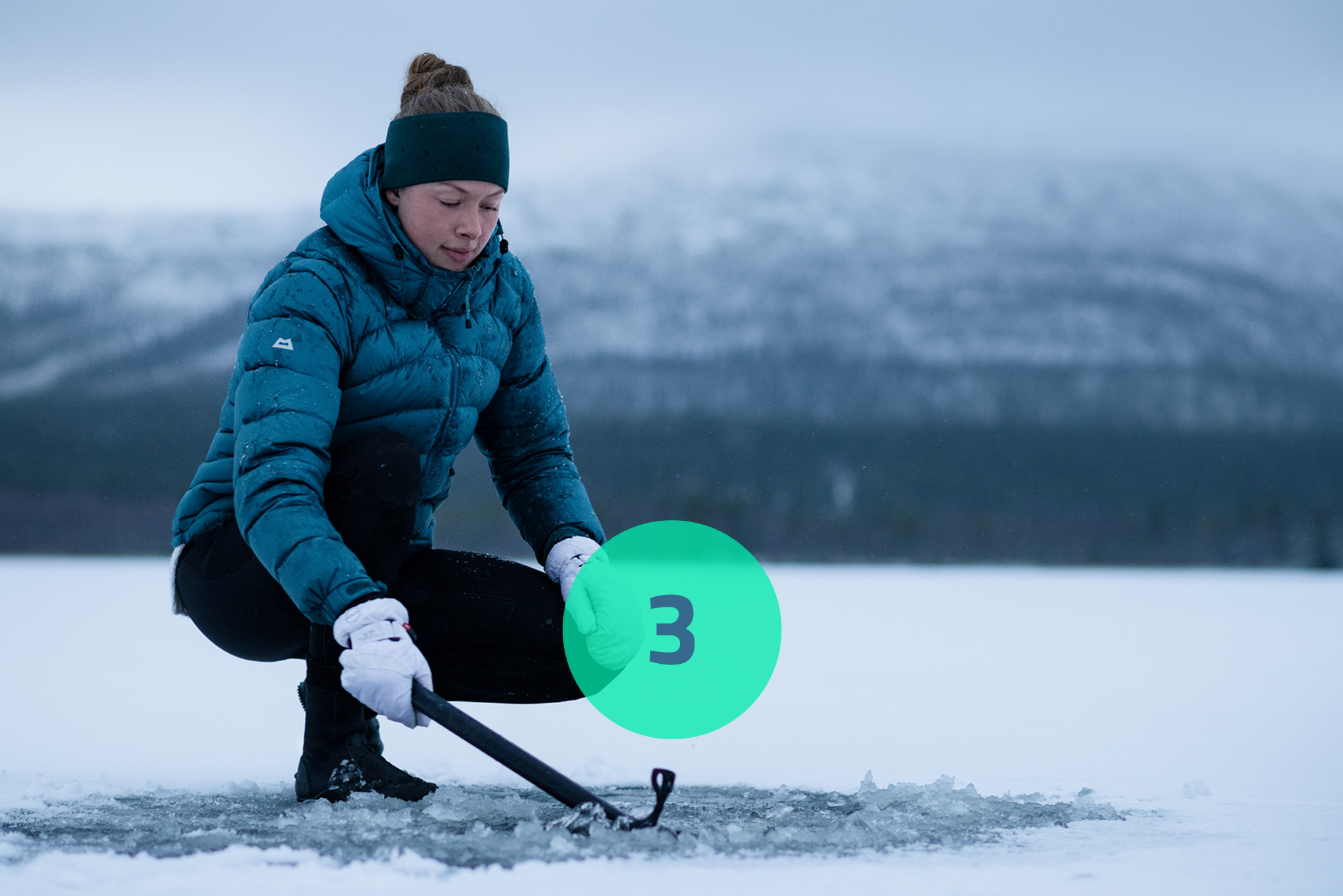Woman with ice axe on a frozen lake. 