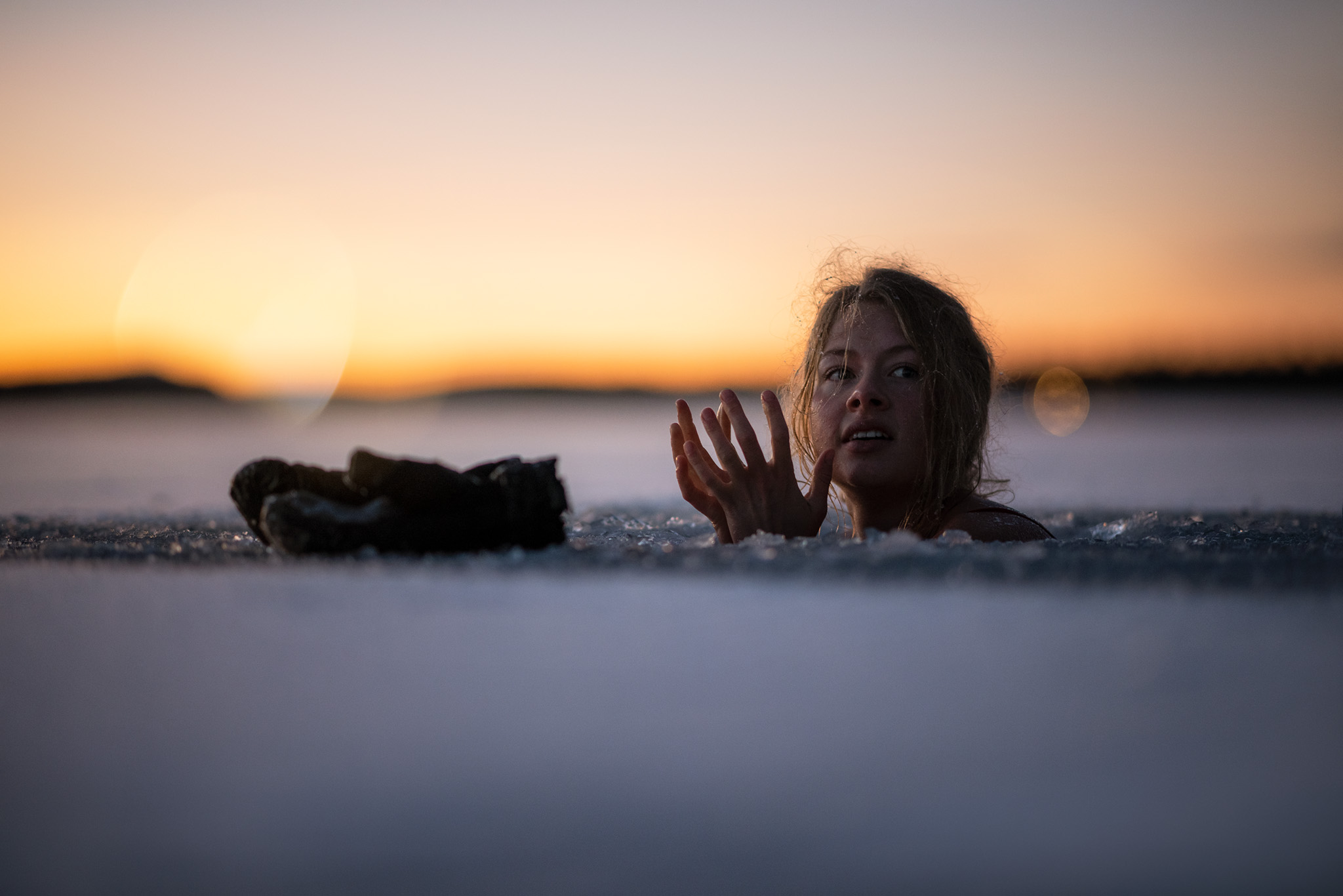 Woman bathing in frozen lake.