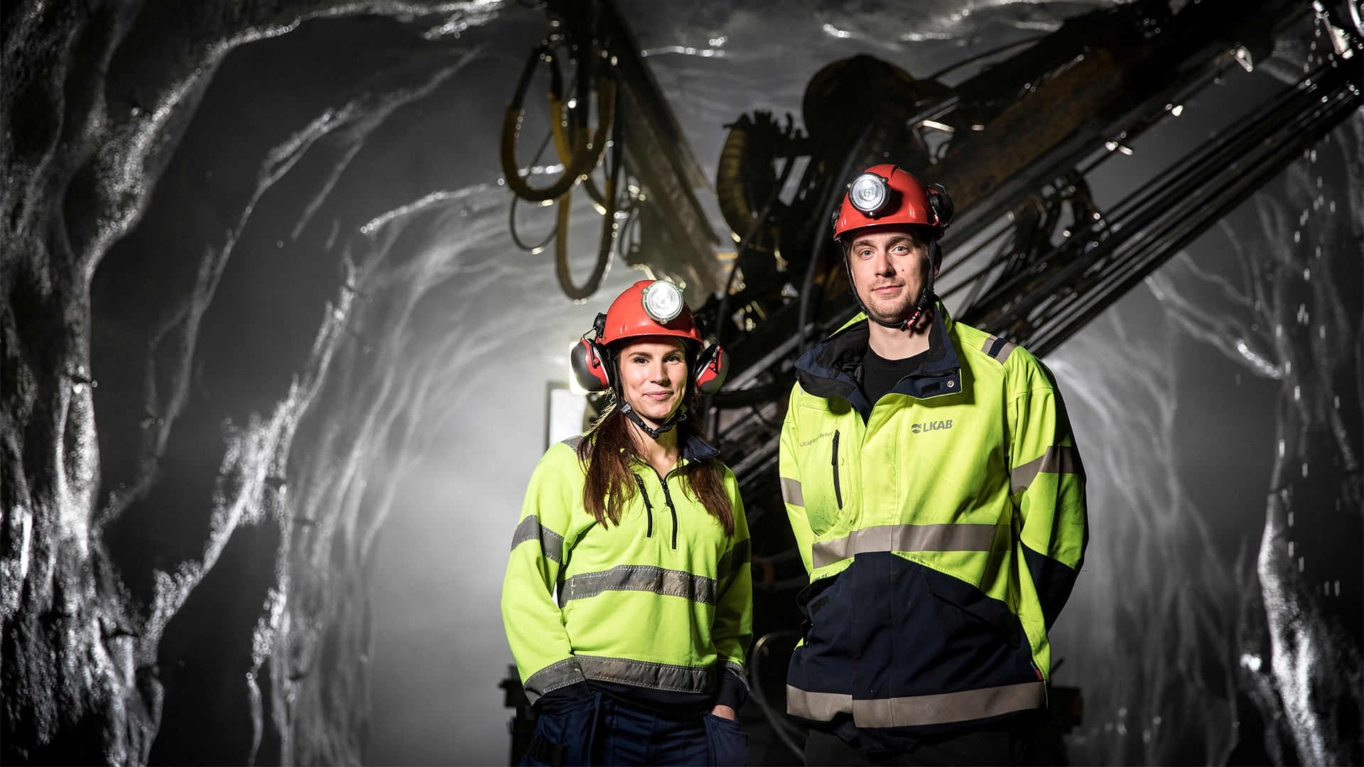 Two people in high visibility clothing in the mine. 