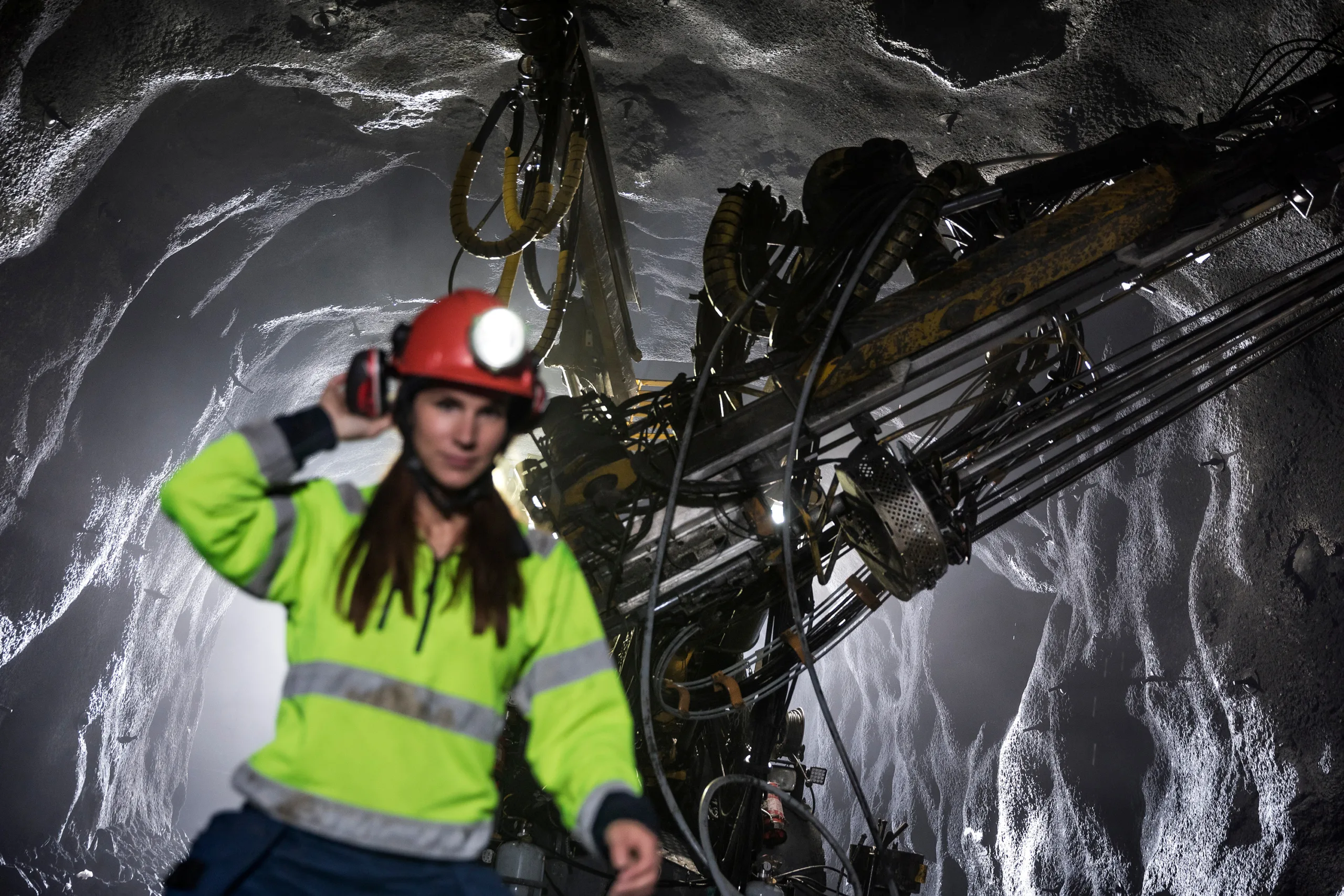 Woman in mining clothes in underground environment. 