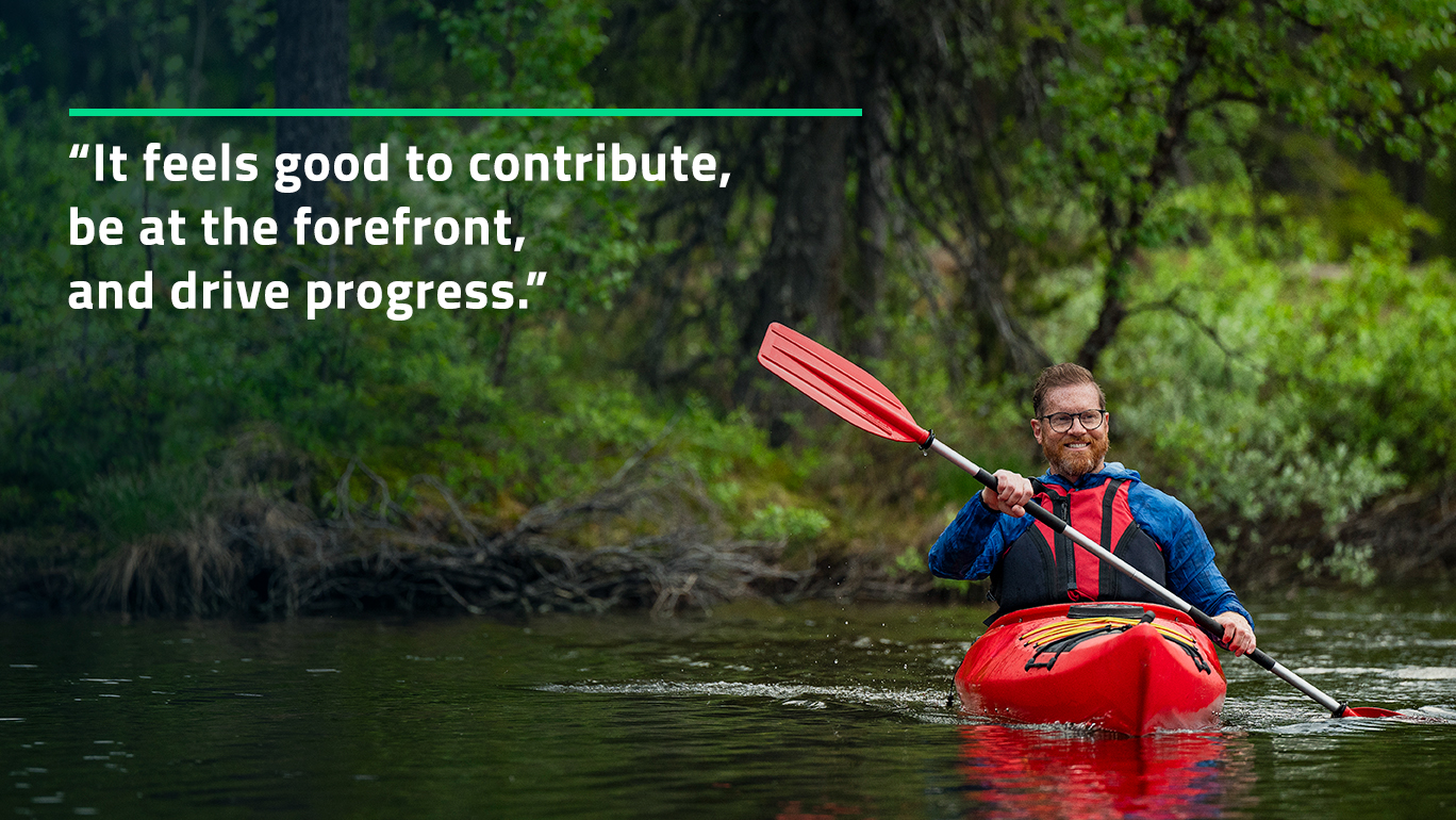 Man in kayak, with quote in the image: "It feels good to contribute, be at the forefront, and drive progress."